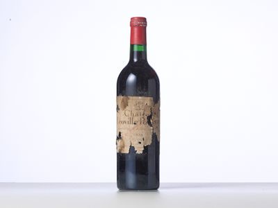 a bottle of red wine sitting on top of a table