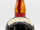 an image of a bottle of brandy sitting on a white surface