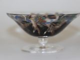 a glass bowl with a design on it sitting on a table