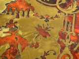 a close up of a gold and red table cloth