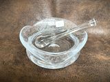 a glass bowl with a spoon in it on a table