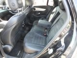 a black car with a black seat and a black bag in the back seat