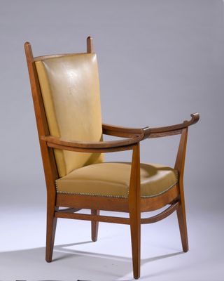 an image of a wooden chair with a tan leather upholstered seat