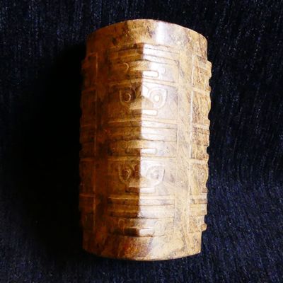 a close up of a wooden object on a black surface
