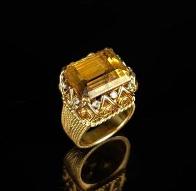 a close up of a gold ring with a citrine stone