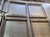 a metal table with a bunch of metal trays on top of it