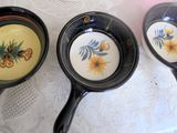 three pans that are sitting on a table