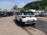 a white car parked in a parking lot next to other cars