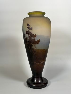 a vase with a painting on it sitting on a table