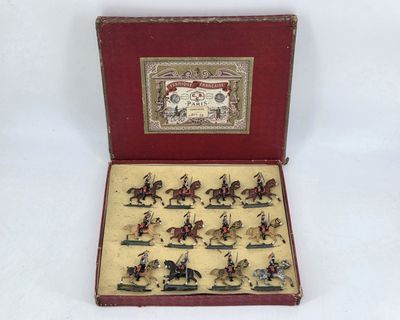 a small box with miniature figurines of people riding horses