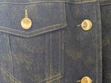 denim jacket with gold buttons on the back of the jacket