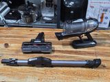 two vacuums that are on a table next to a coffee maker