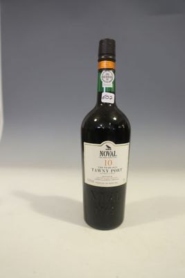une bouteille de vin posée sur une table à côté d'un verre à vin