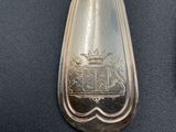 a silver spoon with a picture of a train on it