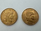 two gold sovereigns, one of which has a head of a woman and one of which is a man