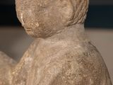 a stone statue of a man with a bird on his shoulder