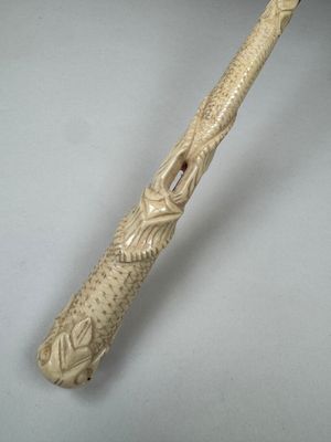 an image of a wooden bat with a carved handle on a table