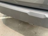 a close up of a car ' s bumper with a hole in it