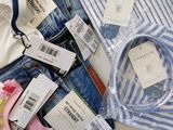 a lot of clothes that are sitting on a table