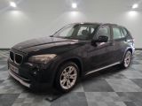 a picture of a black bmw suv parked in a garage
