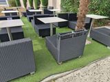 many tables and chairs that are on the grass