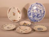 five plates and a bowl sitting on a table
