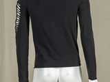 a mannequin wearing a black shirt and white pants