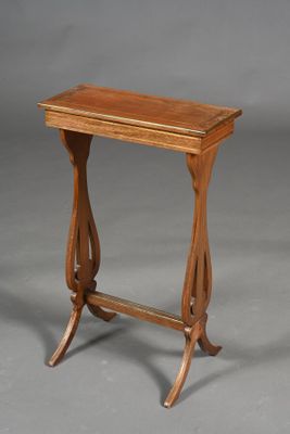 an old wooden table with a wooden top on a gray background