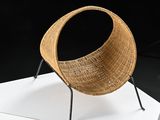 an image of a wicker chair on a white pedestal