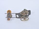 a toy of a horse drawn carriage with a man in it