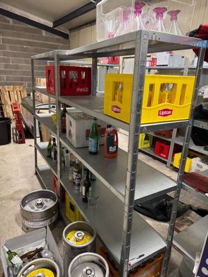 many kegs on the shelves in the garage