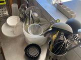 several kitchen utensils are sitting on a counter in front of a window