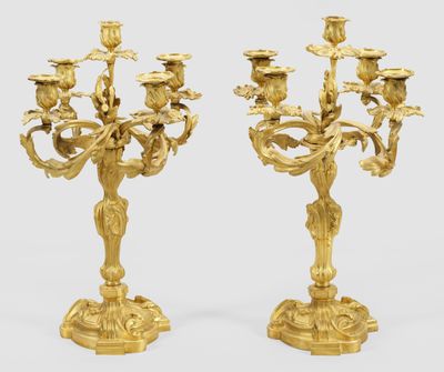 pair of antique brass candelabs with flowers and leaves