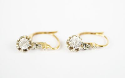a pair of gold and diamond earrings on a white background