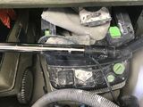 a close up of a car engine with a hose and a tool box