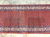 rug on the floor is red and white with a pattern on it