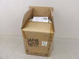 a cardboard box with a label on it sitting on the floor