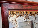a mirror with a gold lettering on it in a room
