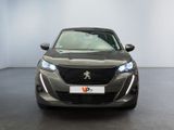 the front view of a grey car parked in a showroom