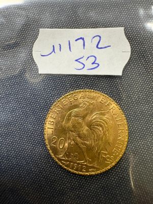 a close up of a gold coin with a label on it