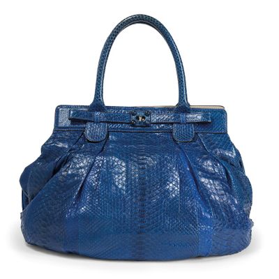 a close up of a blue handbag on a white background