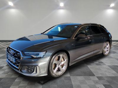 a grey audi wagon parked on a checkered floor in a showroom