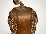 an image of a brown vase with a bird on top