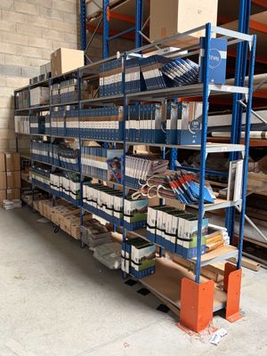 a large rack with many items on it in a warehouse