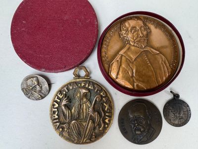 some of the medals are sitting on the table next to each other