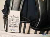 a black and white bag with a price tag on it