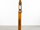 an old wooden clock with a bird on the top of it