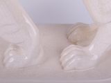 a white statue of a bear on a white surface