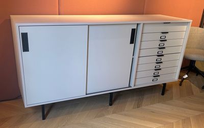 white cabinet with drawers and drawers on top of it in a room
