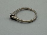 a silver ring that is on a white surface